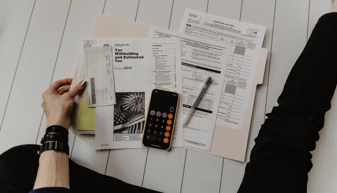 Bookkeeper reviewing bank statements and bookkeeping records on a laptop
