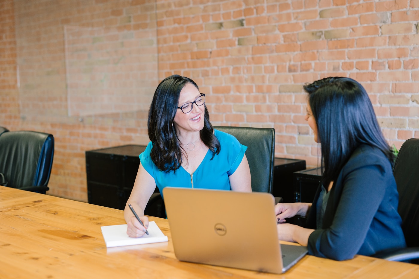 Professional business planning discussion with financial documents on a desk